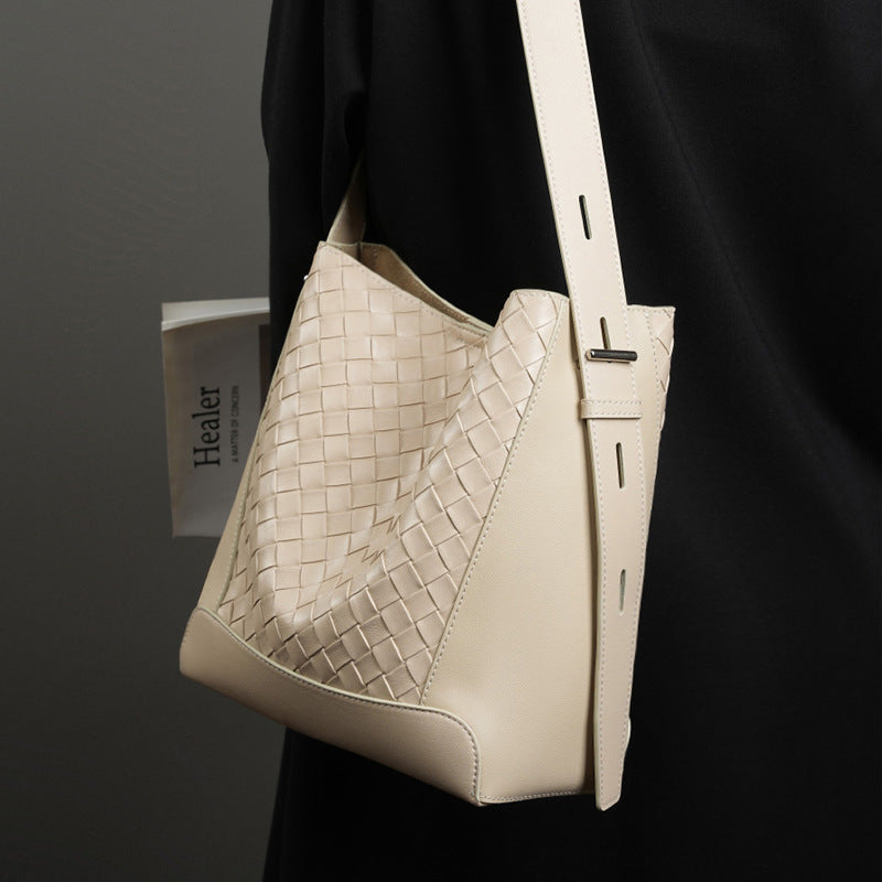 Beige leather shoulder bag with woven detail and top handle