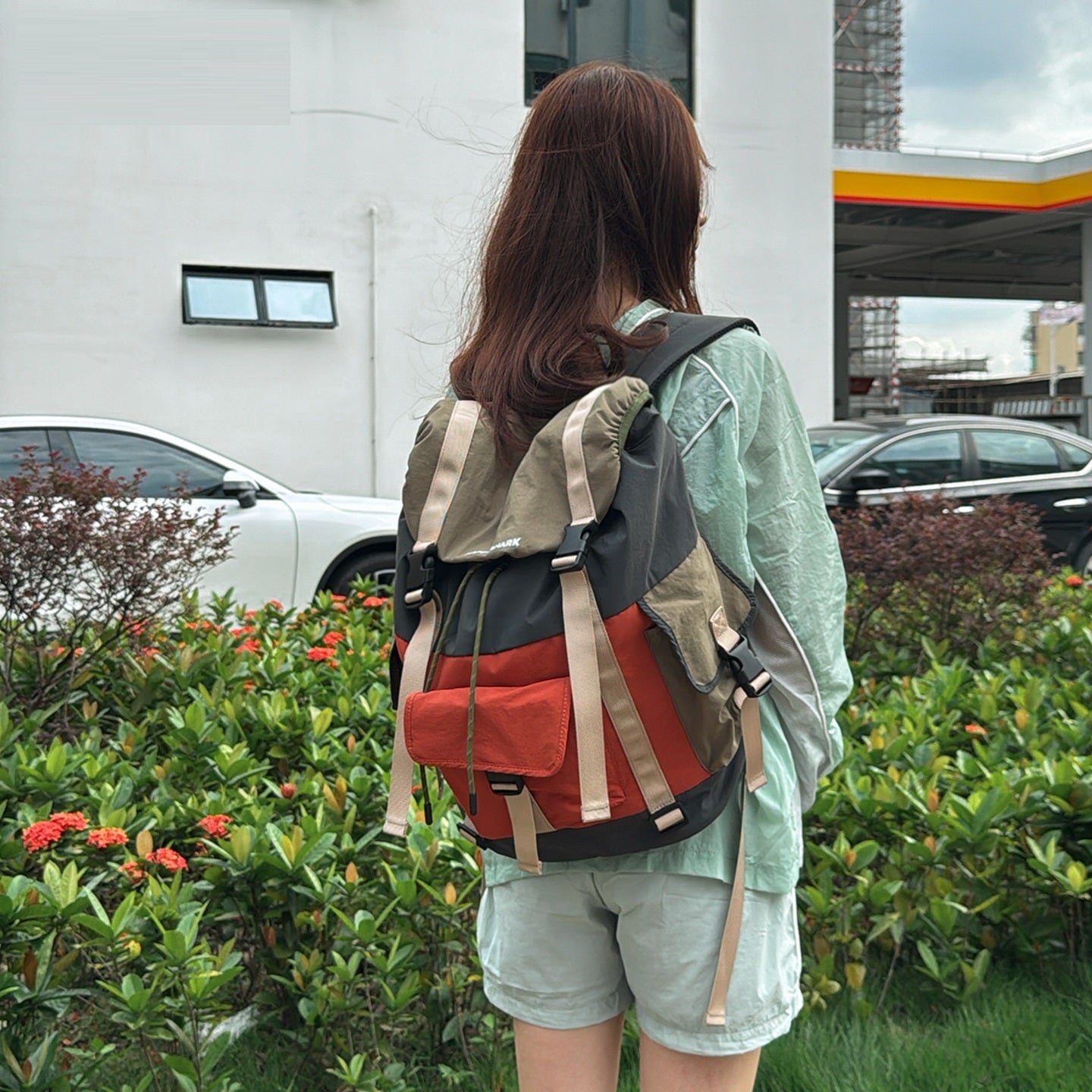 Side view of unisex nylon outdoor backpack with zipper compartments