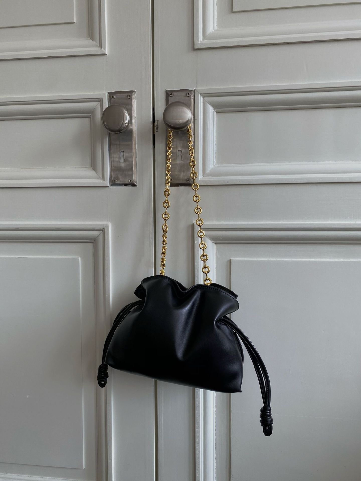 Side profile of women's brown soft leather bucket shoulder bag