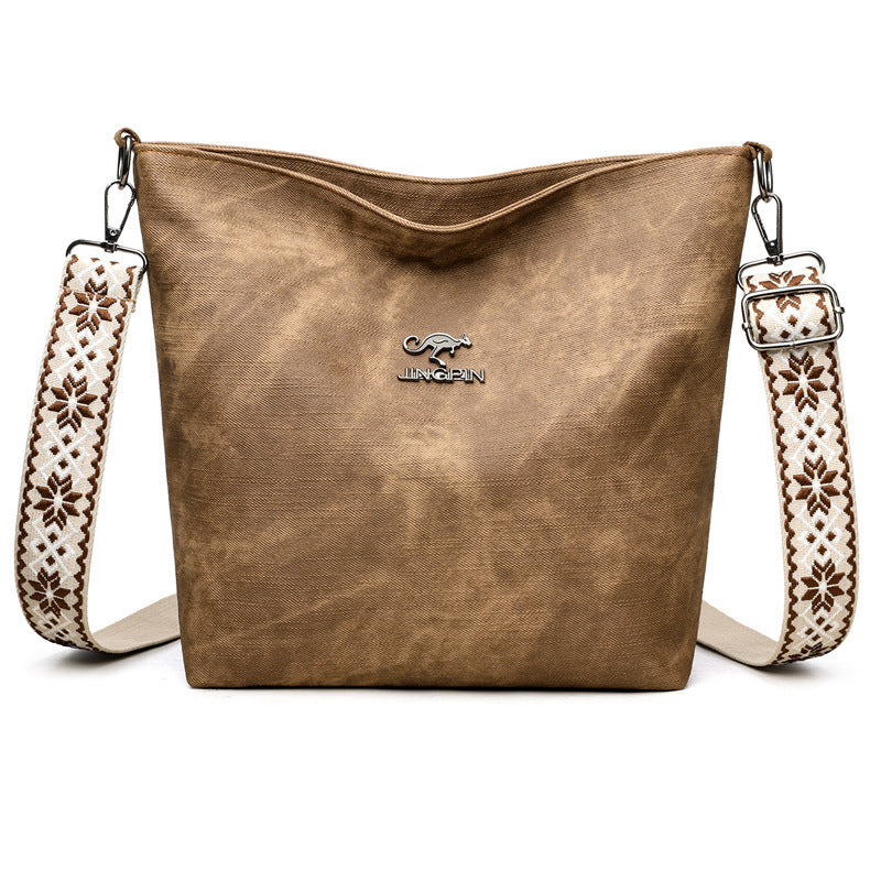 Close-up of shoulder strap on PU leather crossbody tote bag