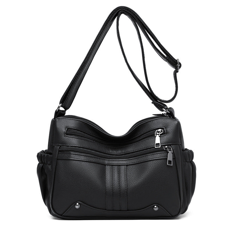 Black handbag with a shoulder strap on a white background
