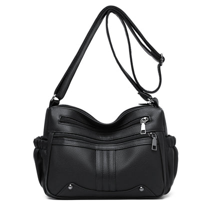 Black handbag with a shoulder strap on a white background