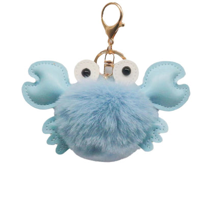 Blue crab-shaped keychain with a fluffy body