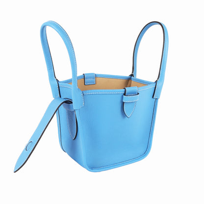 Blue handbag with a strap on a white background