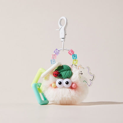 Blush ladybug keychain hanging on a purse