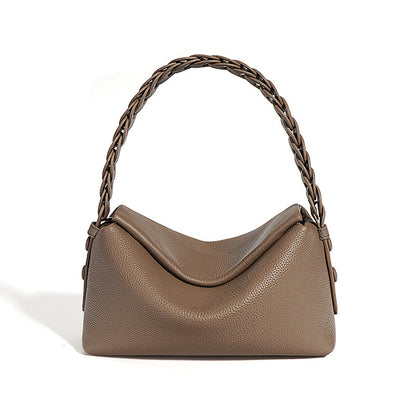 Brown handbag with braided handle on a white background