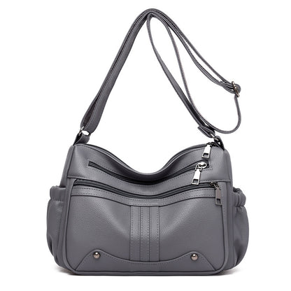 Gray handbag with a shoulder strap on a white background