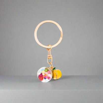 Keychain with colorful fruit charms on a light gray background