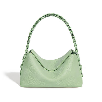 Light green handbag with braided handle on a white background