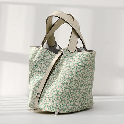 Patterned tote bag with beige straps on a light gray background