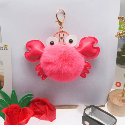 Pink crab-shaped keychain with a fluffy body