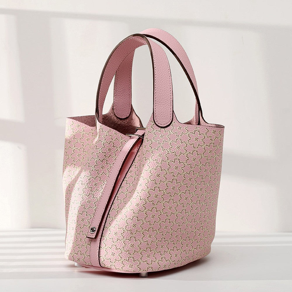 Pink floral-patterned handbag on a light gray background
