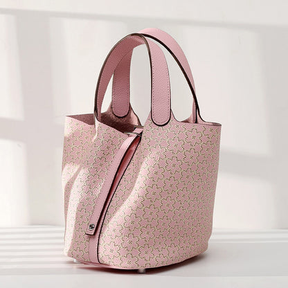 Pink floral-patterned handbag on a light gray background