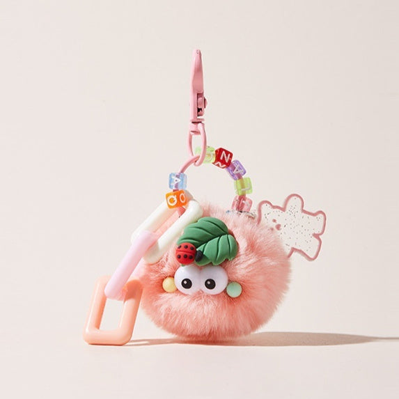 Pink plush toy with a ladybug and leaf design