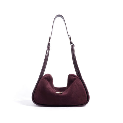 Purple handbag with a shoulder strap on a white background