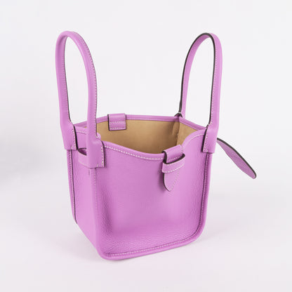 Purple handbag with handles on a light gray background