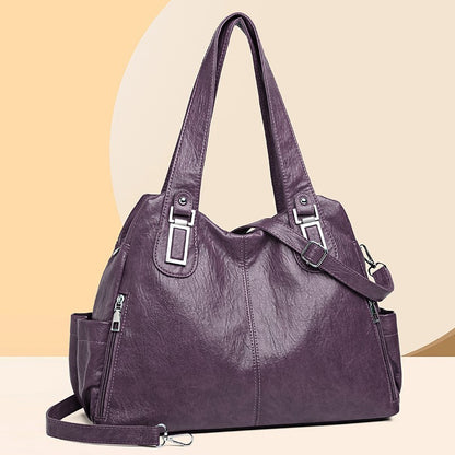 Purple handbag with multiple straps on a beige background