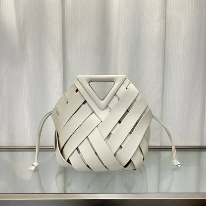 White woven bag with a geometric design on a reflective surface