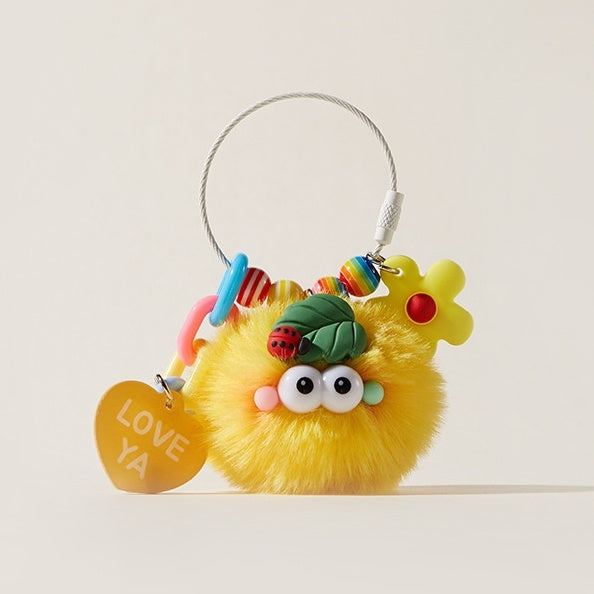 Yellow fluffy keychain with colorful decorations