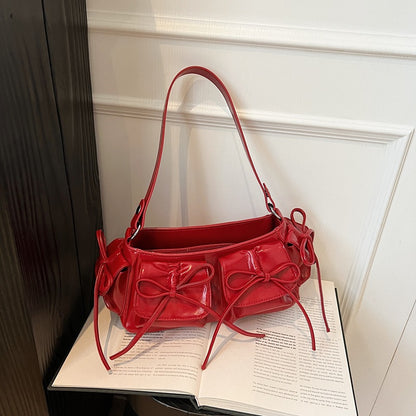 Apricot pleated PU handbag with tassel bow in front view
