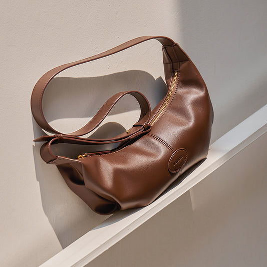 Side angle of soft dumpling cowhide crossbody bag