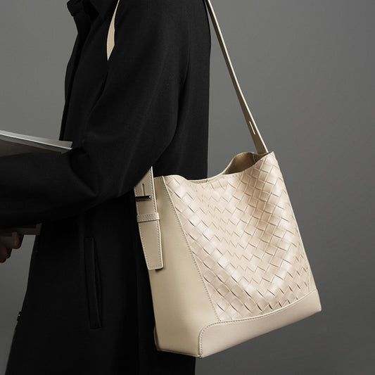 Beige crossbody leather bag with woven texture and soft structure