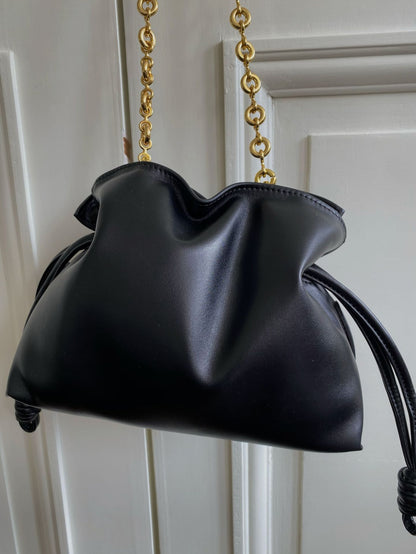 Woman modeling black cowhide leather bucket shoulder crossbody bag