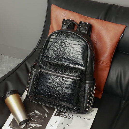 Front view of black PU leather laptop backpack with rivet accents