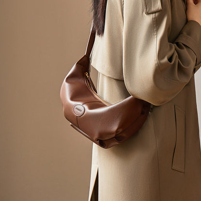 Front view of brown croissant-style leather shoulder bag