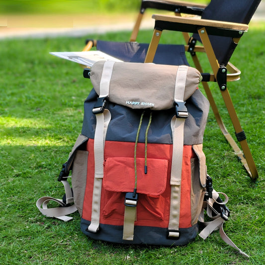 Front view of orange and green waterproof outdoor backpack with multiple compartments