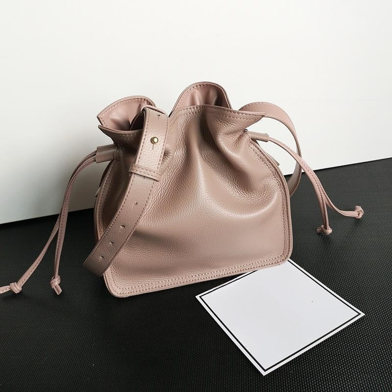 Woman wearing gray first layer cowhide pull-belt crossbody bucket bag