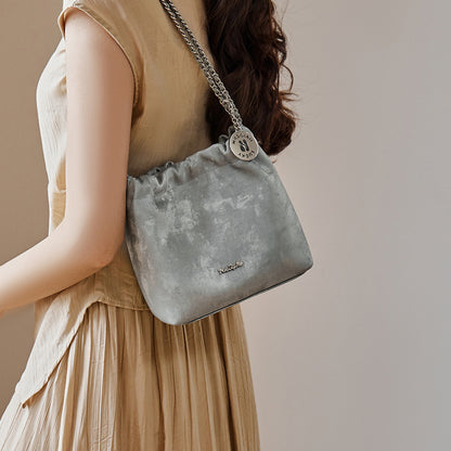 Front view of cowhide chain bucket crossbody bag