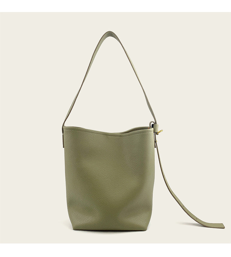 Close-up of strap and stitching on light khaki cowhide leather crossbody bag
