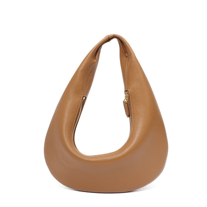 Close-up of soft cowhide texture in minimalist shoulder bag