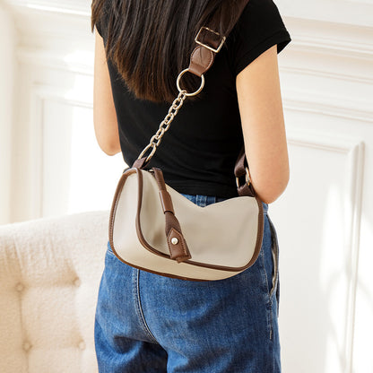 Front view of cowhide underarm saddle crossbody bag
