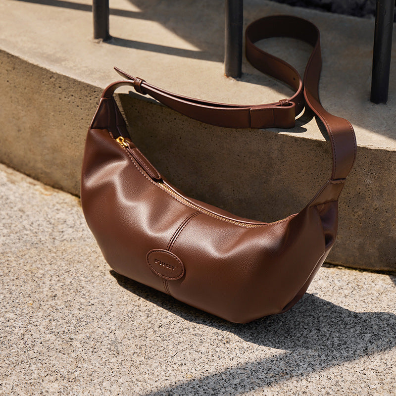 Woman styling croissant bag with urban winter outfit