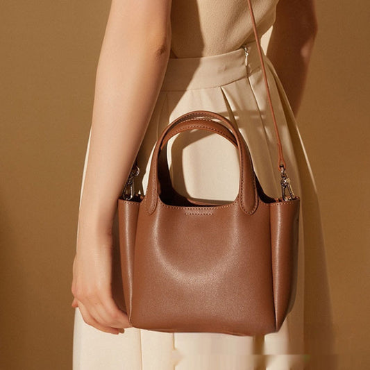 Woman wearing elegant cowhide leather crossbody in lifestyle setting