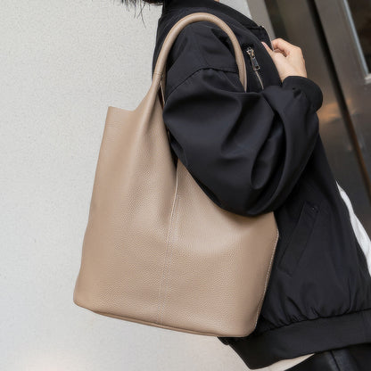 Interior view of khaki bucket-style leather tote with compartments