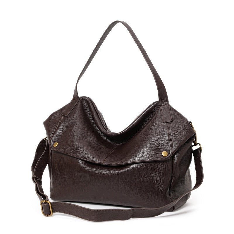 Brown leather shoulder bag placed on office chair