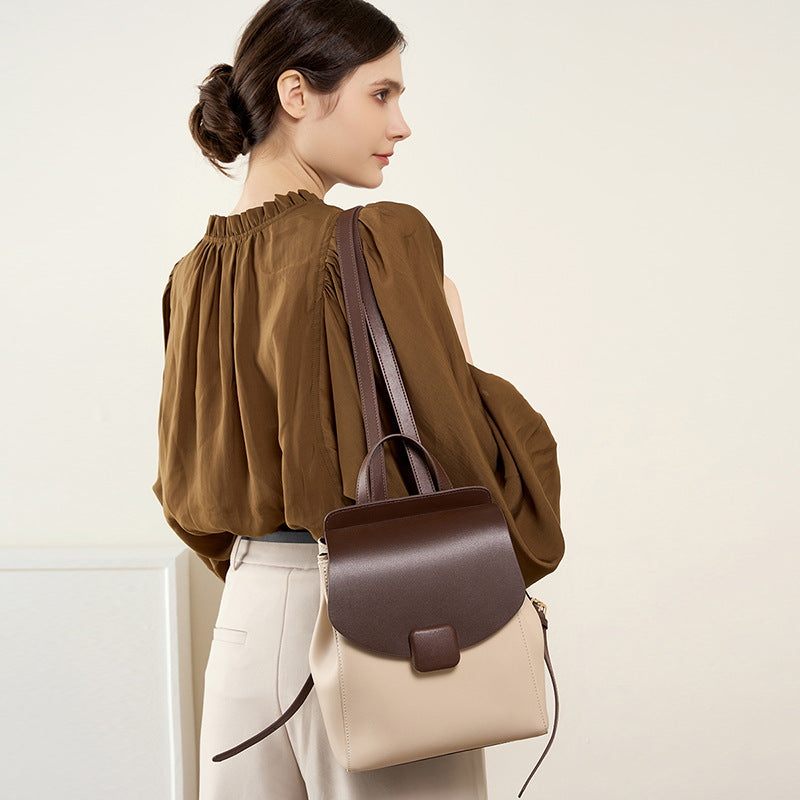 Front view of beige and coffee two-tone leather travel bag