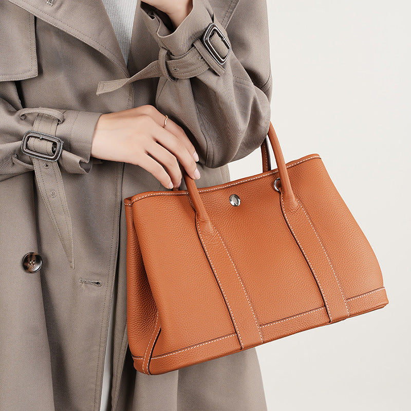 Golden brown leather bucket tote with single strap