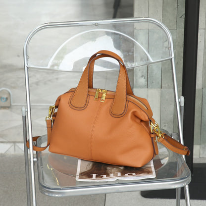 Interior of leather shoulder bag showing multiple compartments