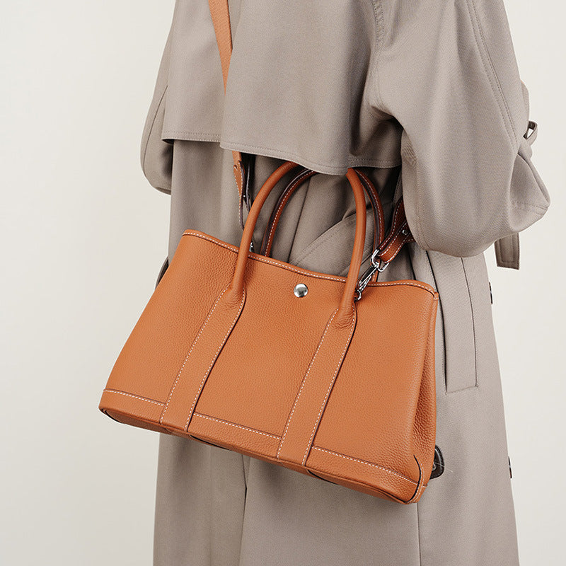 Inside view of leather bag with mobile and zip compartments