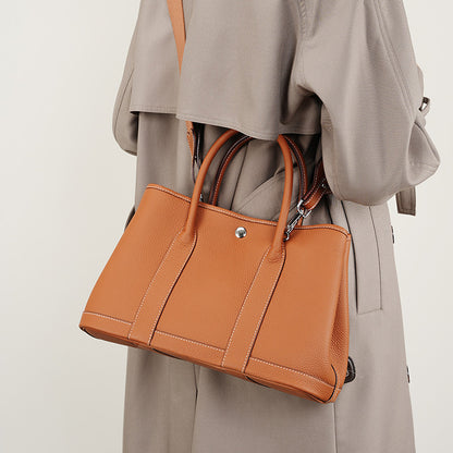 Inside view of leather bag with mobile and zip compartments