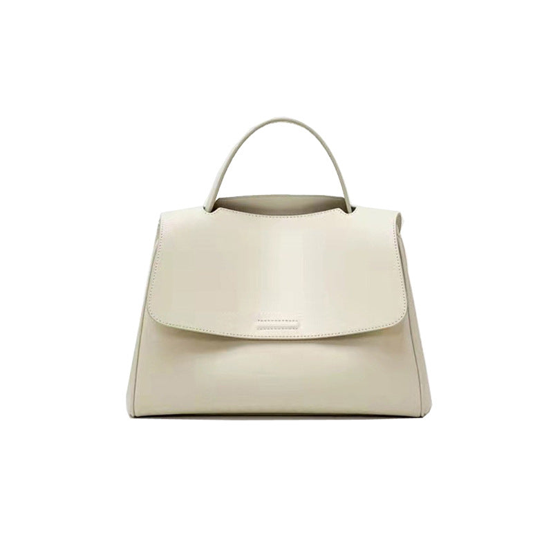 Elegant soft leather bag displayed on white surface