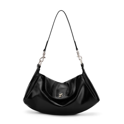 Magnetic snap closure on modern underarm shoulder bag