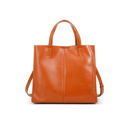 Vintage satchel tote resting on a wooden bench