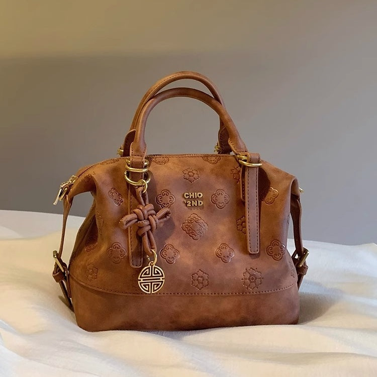 Side angle of brown quilted PU crossbody purse