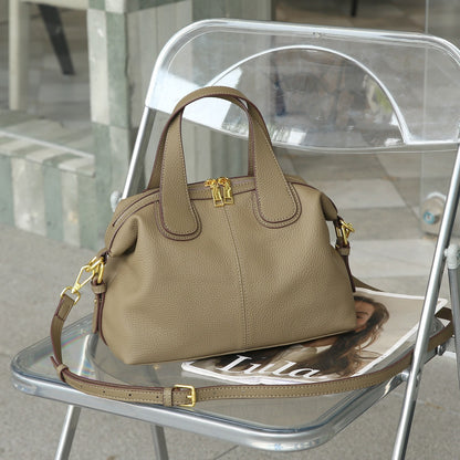 Side view of luxury cowhide crossbody bag with zipper compartments