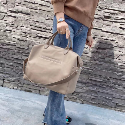 Side view of large waterproof nylon tote with leather trim